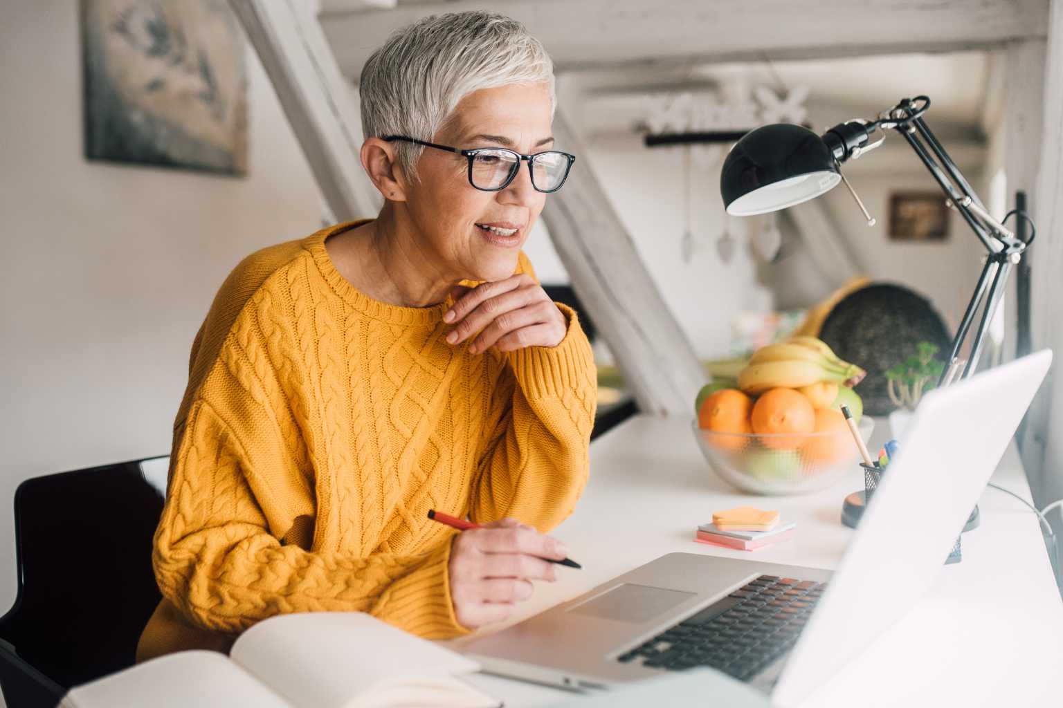 Mature woman working on laptop at desk