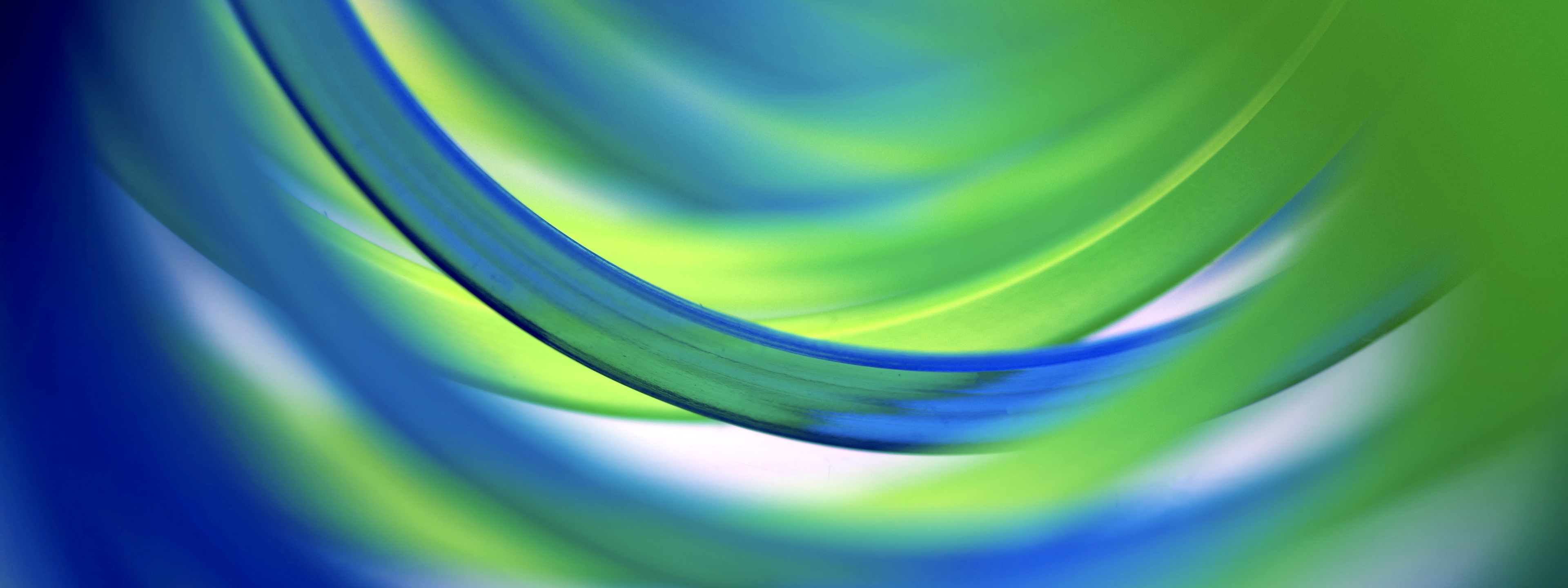 Extreme close-up inside two entwined green and blue coil spring toy