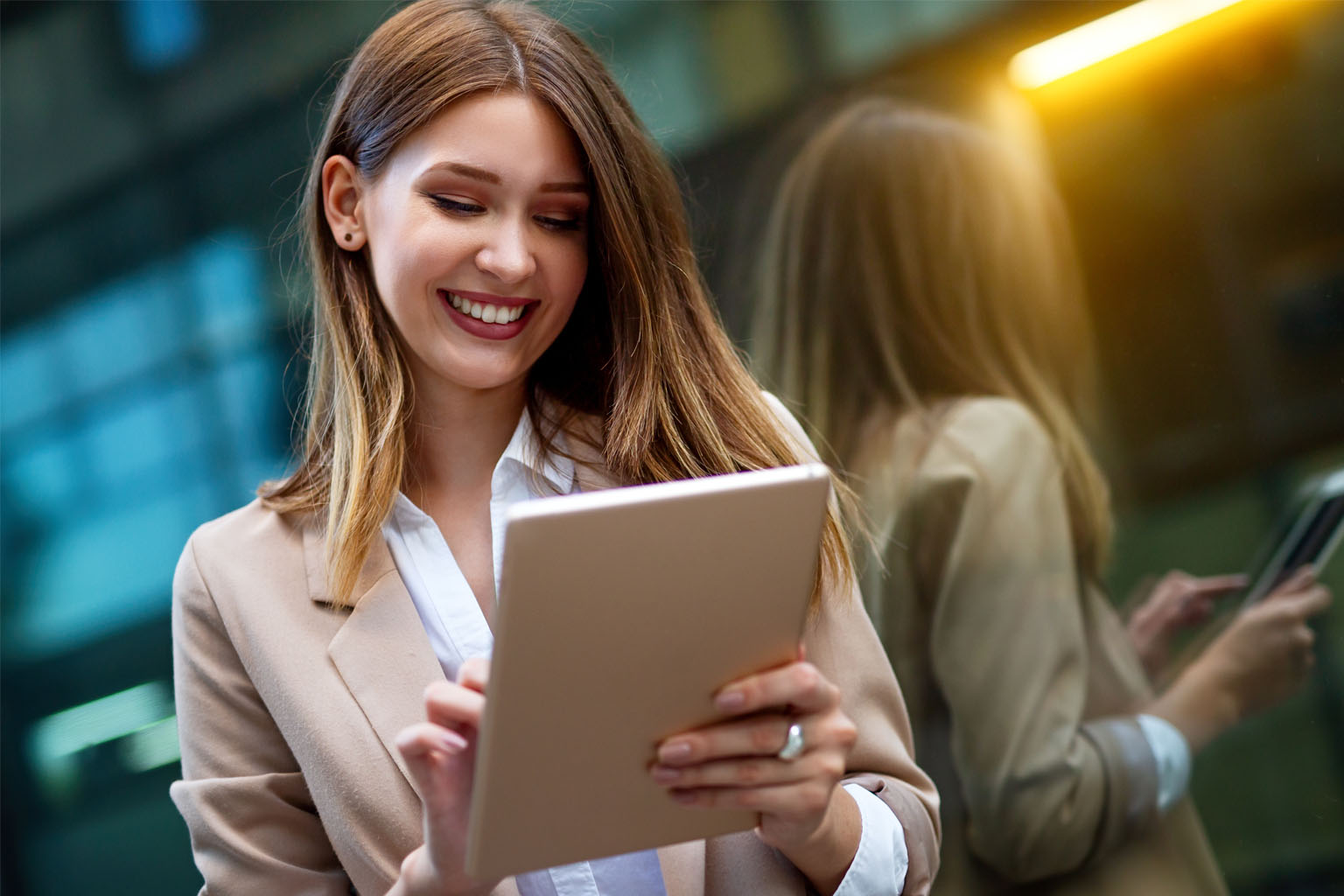 happy woman holding an ipad