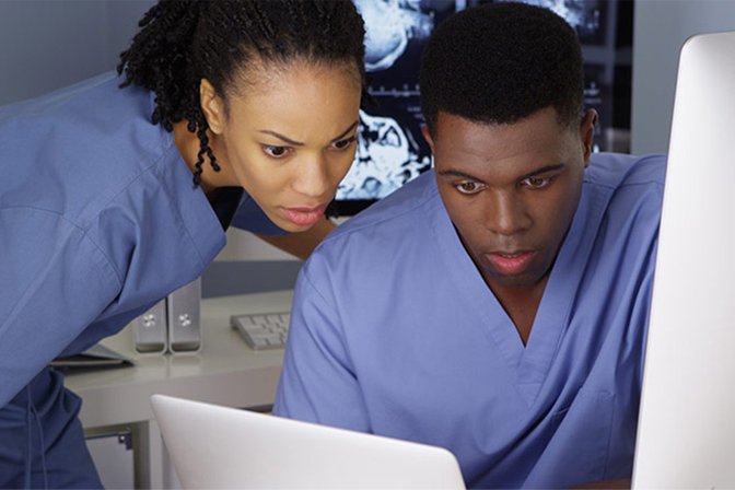 Two nurses looking at computer