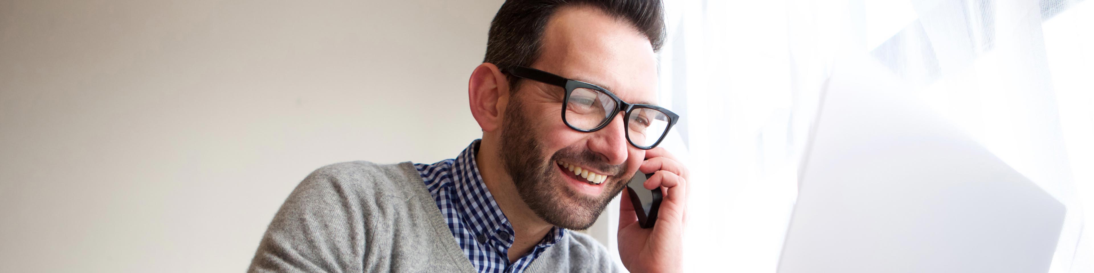 man smiling at laptop