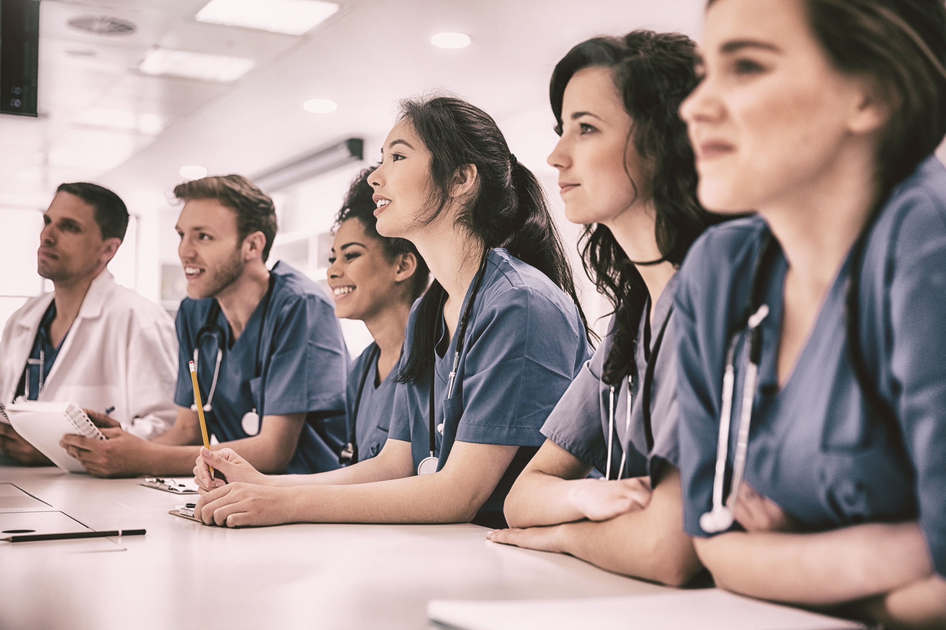 Group of medical students sitting at classroom table