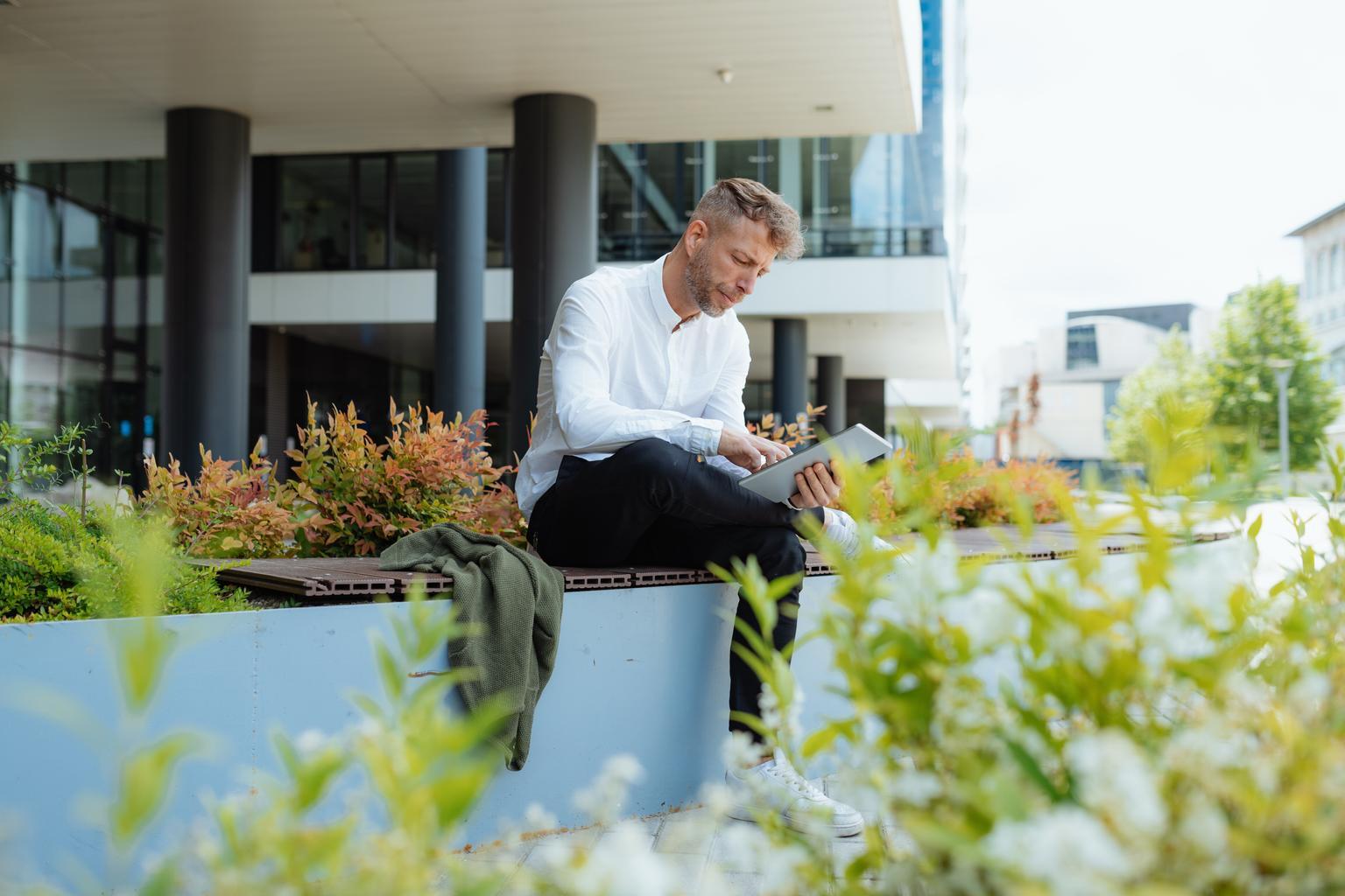 man work on laptop outside