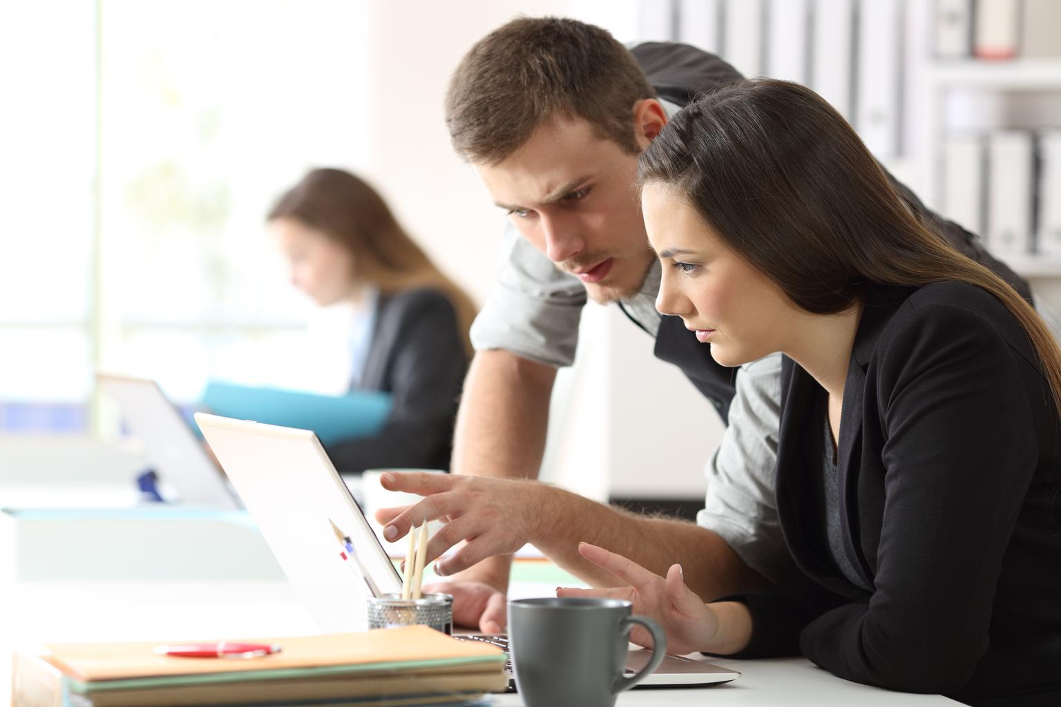 Two office workers working online together