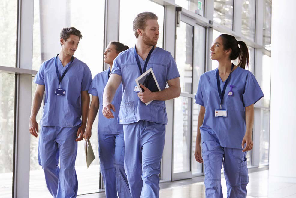 Group of nurses walking down hallway