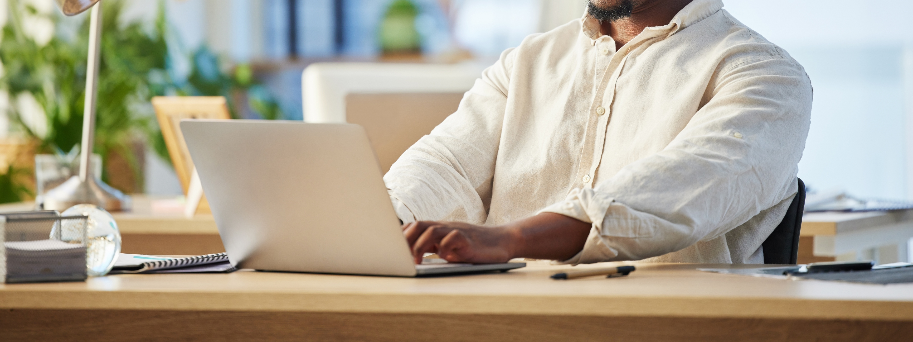 Laptop, business and black man typing, writer and working on web project in office workplace