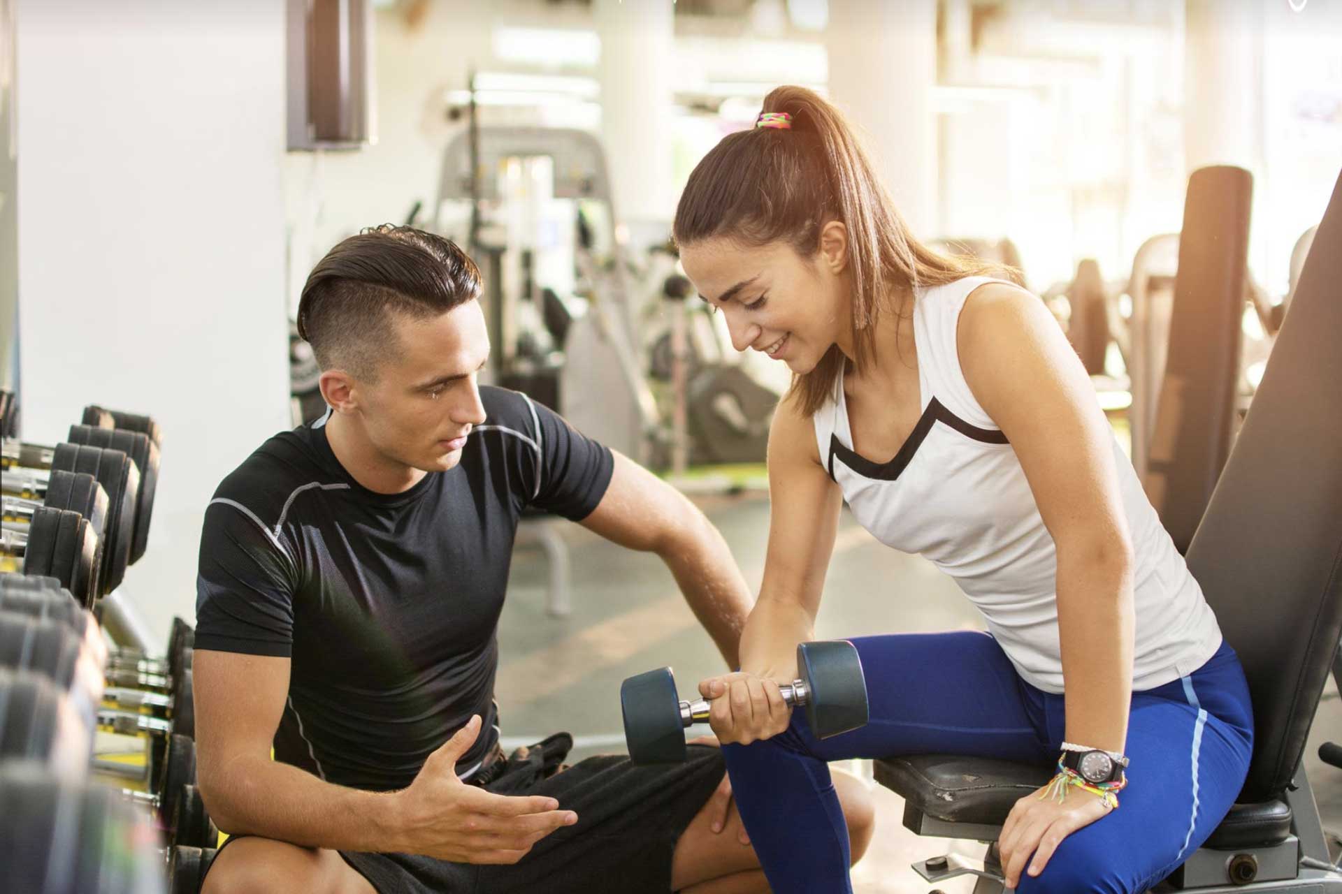 Male personal trainer working with a female client