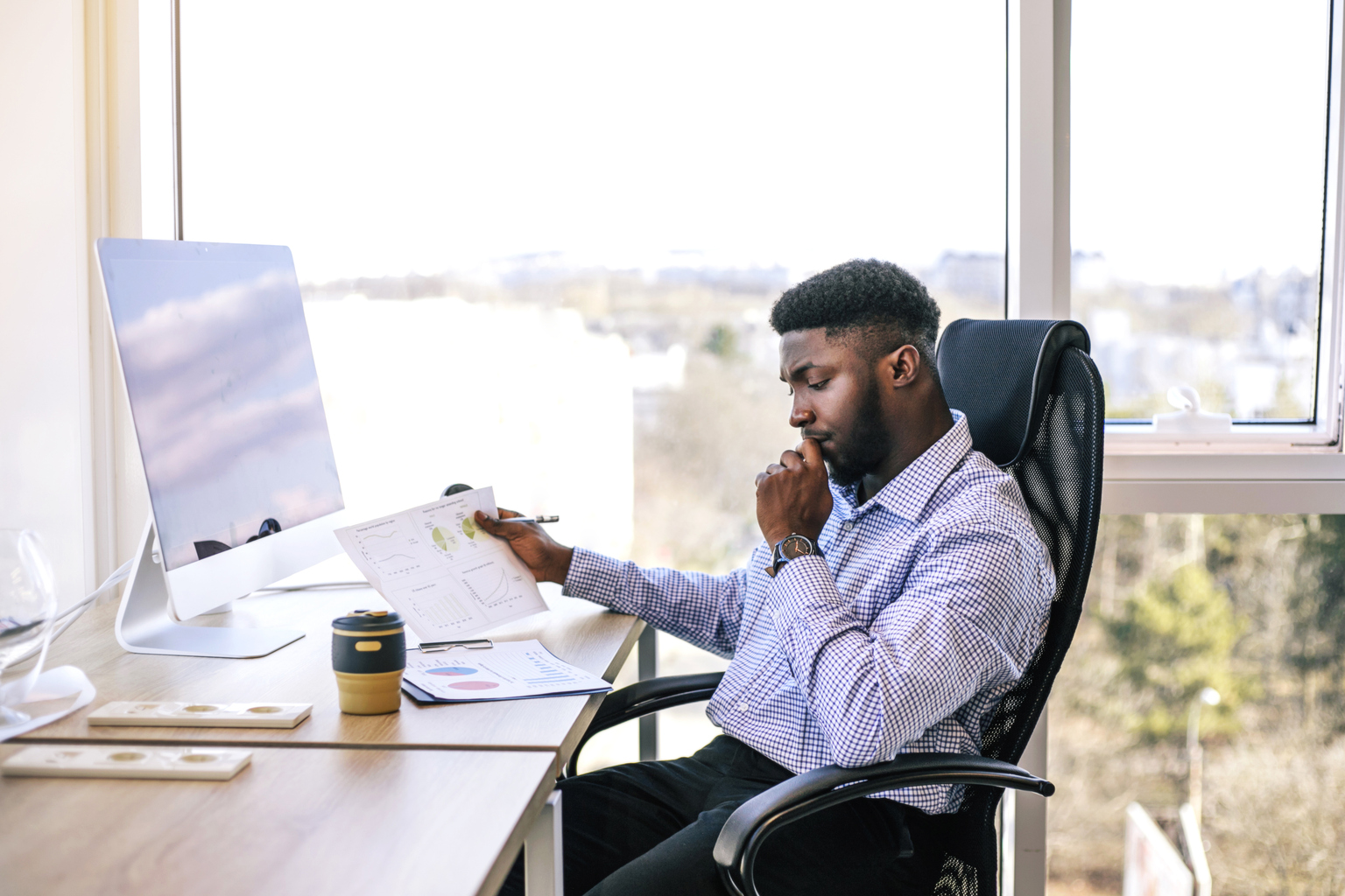 Successful African businessman working on computer in his office