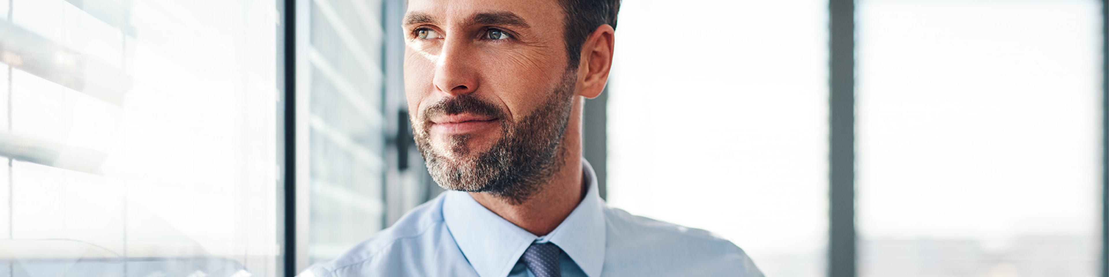 Man looking out an office window