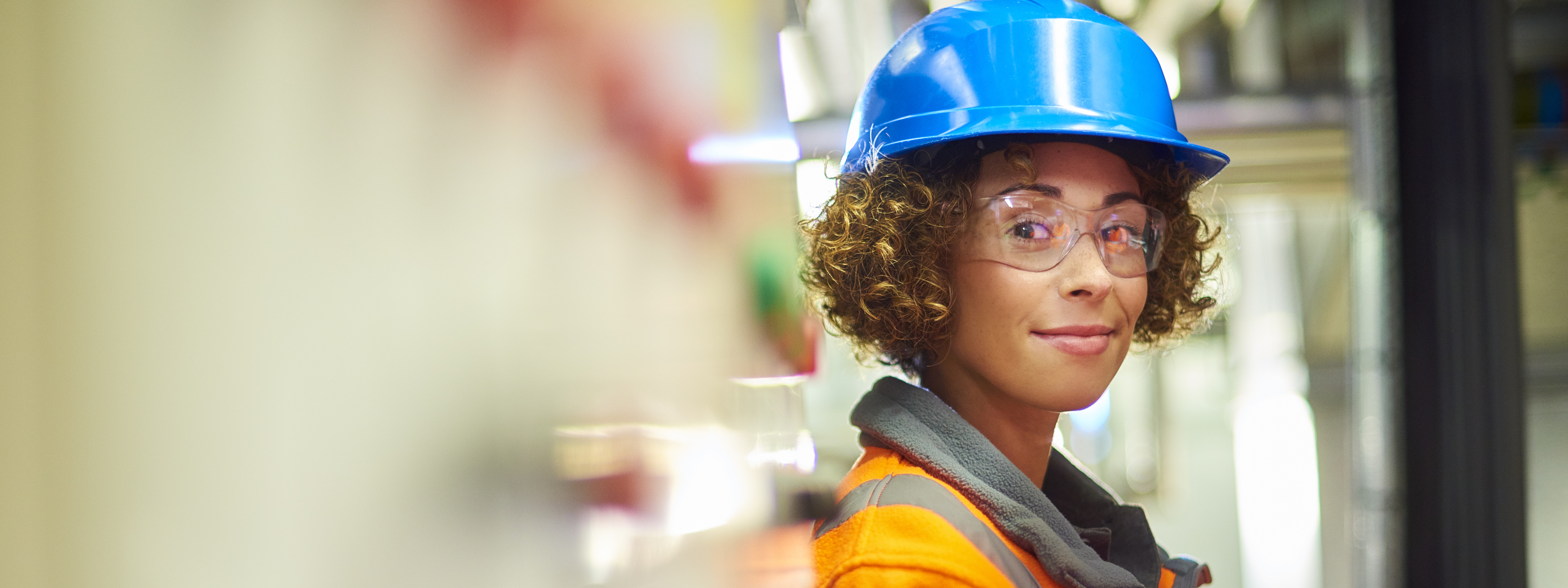 A female industrial service engineer has just conducted a safety check of a control panel in a boiler room