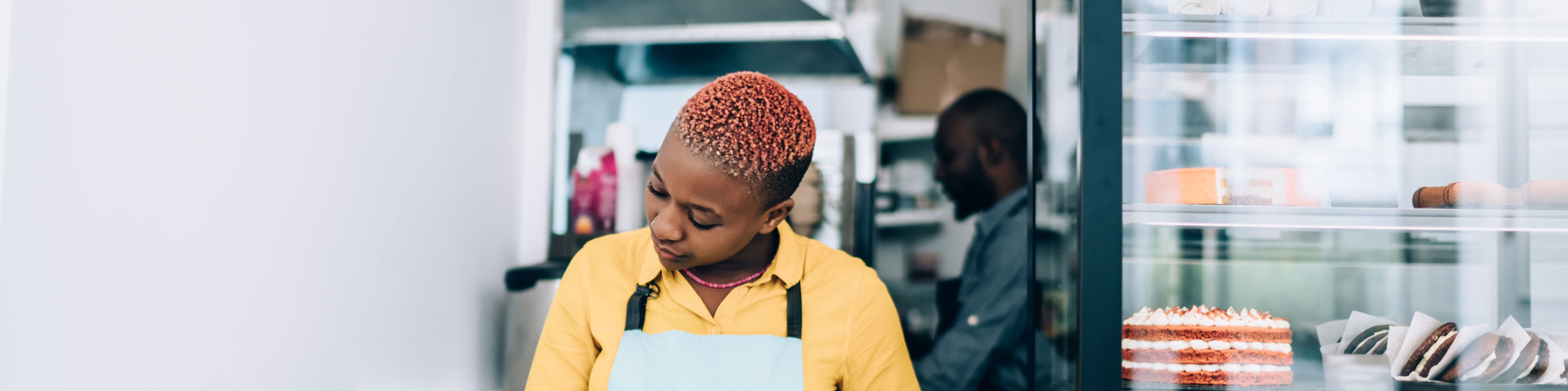 woman with yellow shirt in a bakery