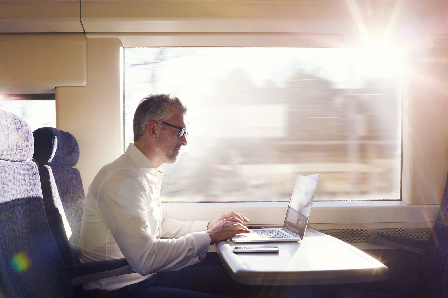 Man working on his Laptop in the train