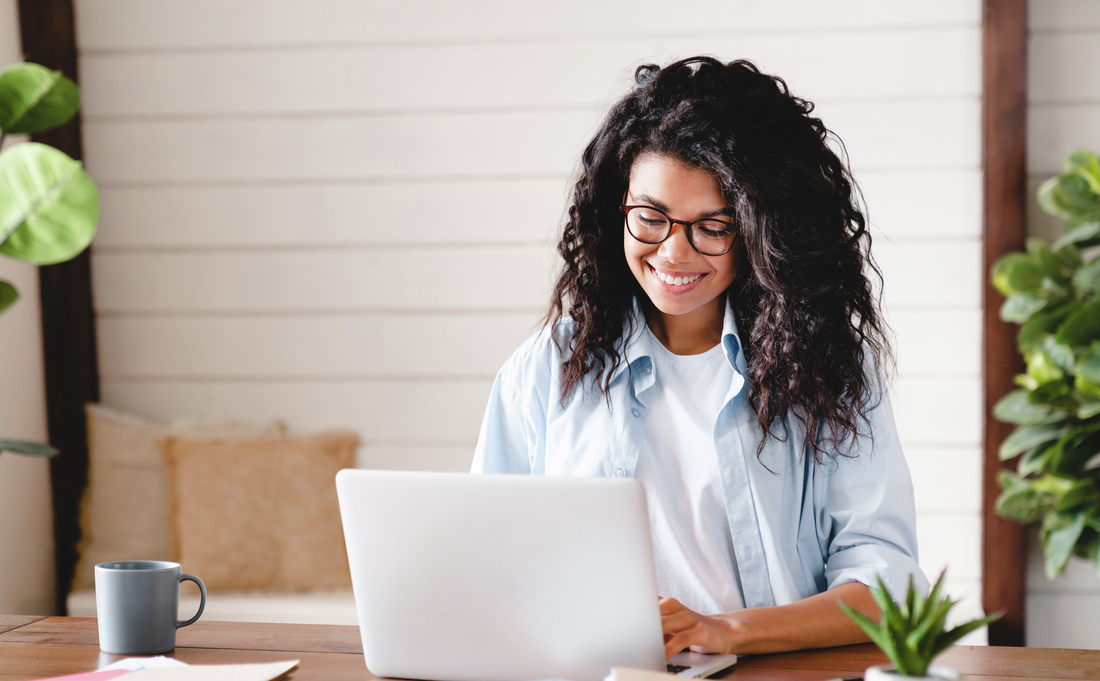 Young woman watching online education webinar using laptop.