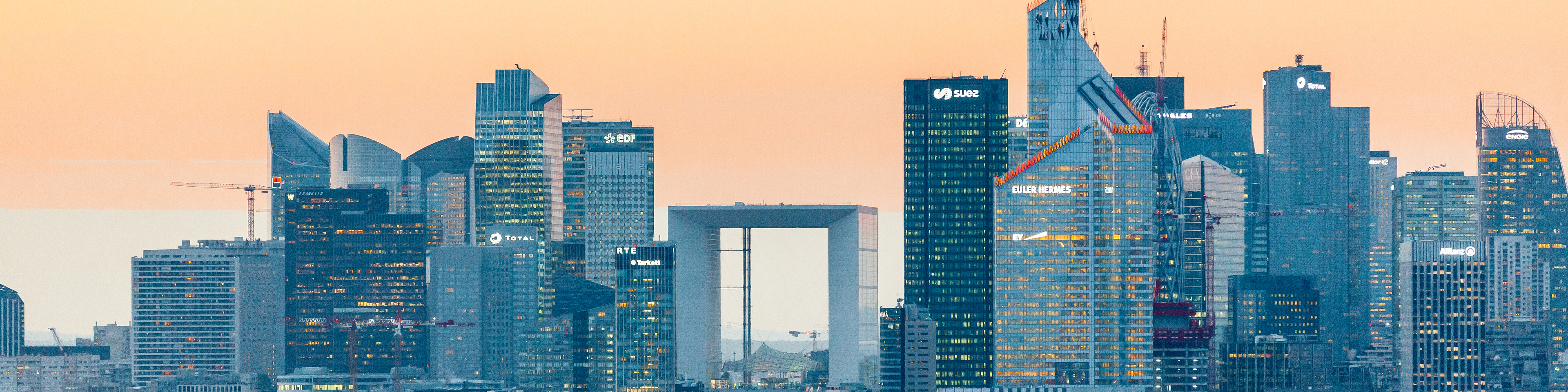 Elevated view of illuminated skyscrapers at La Defense financial district and Avenue des Champs-Elysees at dusk, Paris, France