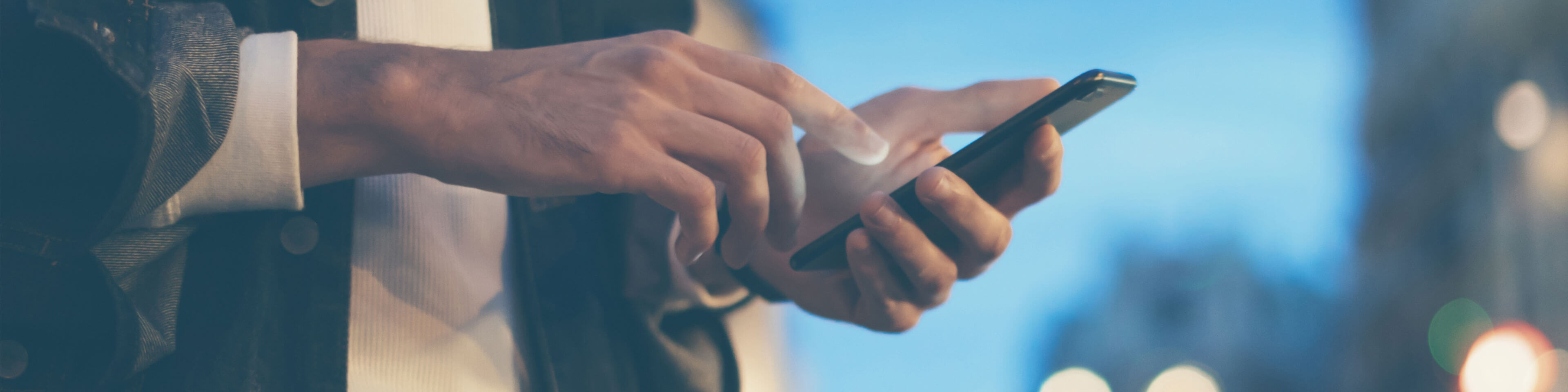 man wearing a suit holding a phone about to click on the phone