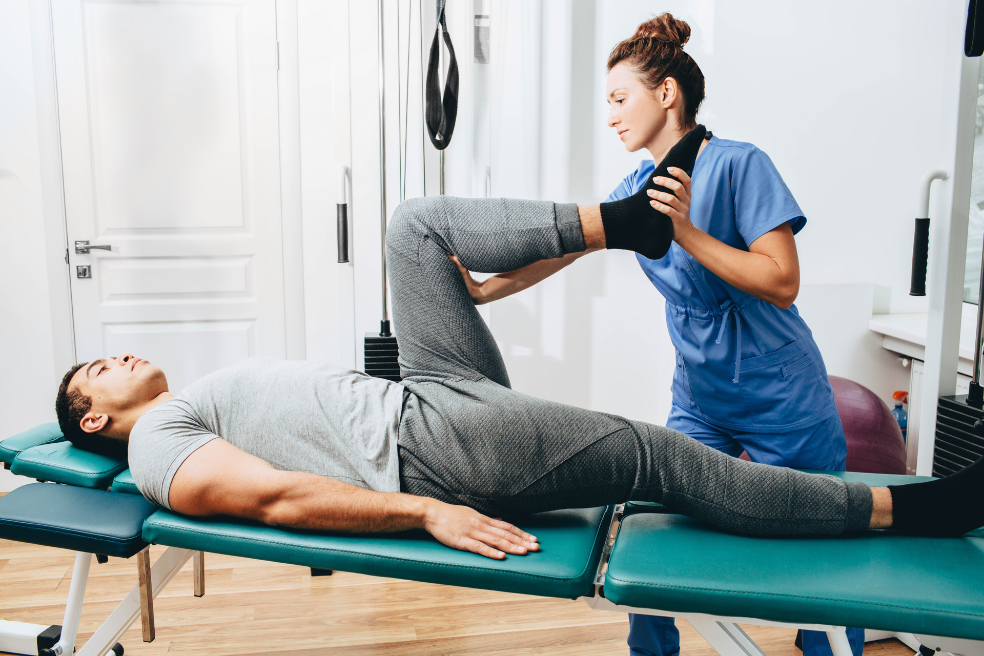 Physiotherapist examines leg condition