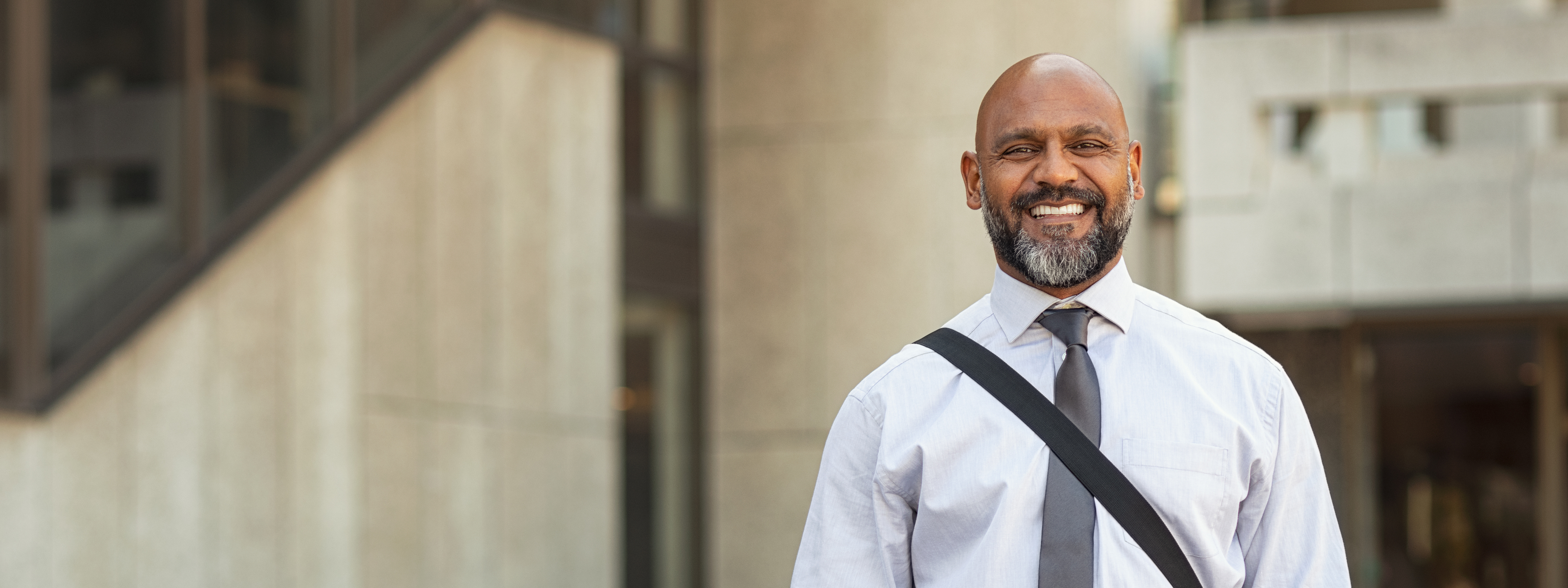 Happy mature businessman standing on street