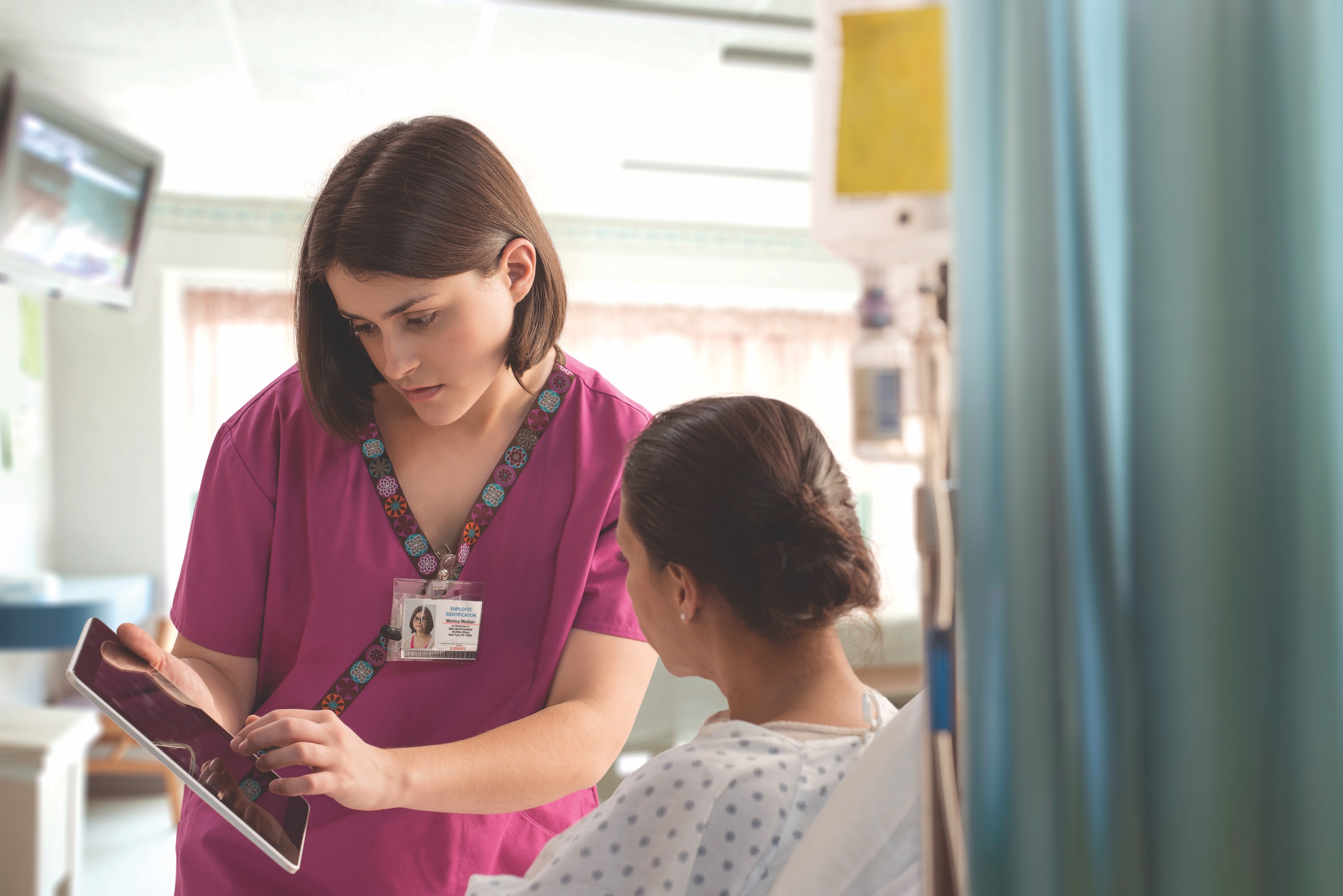 Nurse and patient looking at tablet screen