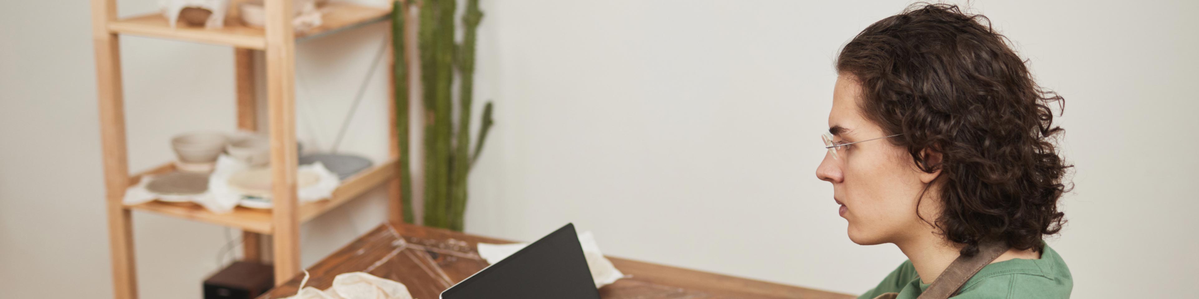 woman on laptop studying tax evasion