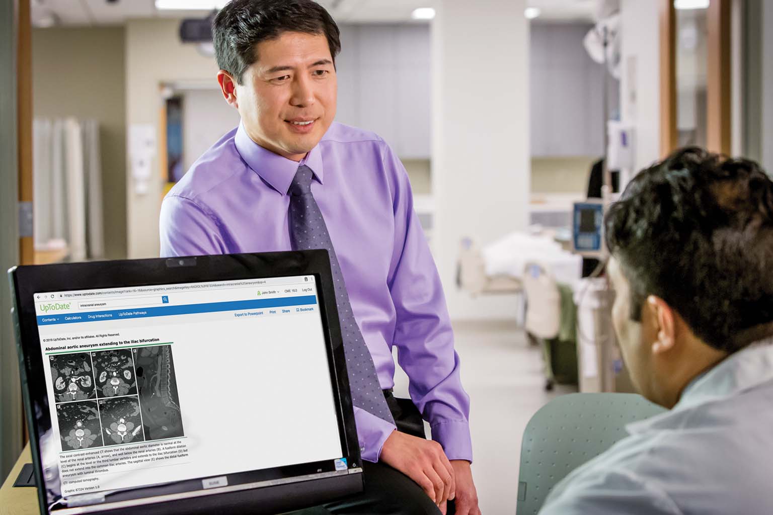 two doctors discussing information displayed on a monitor