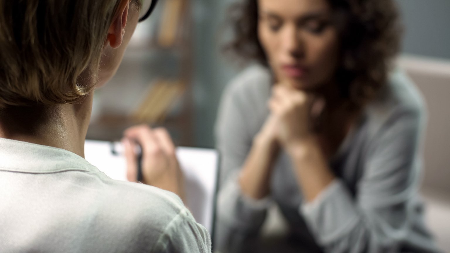 Young woman talking to psychologist