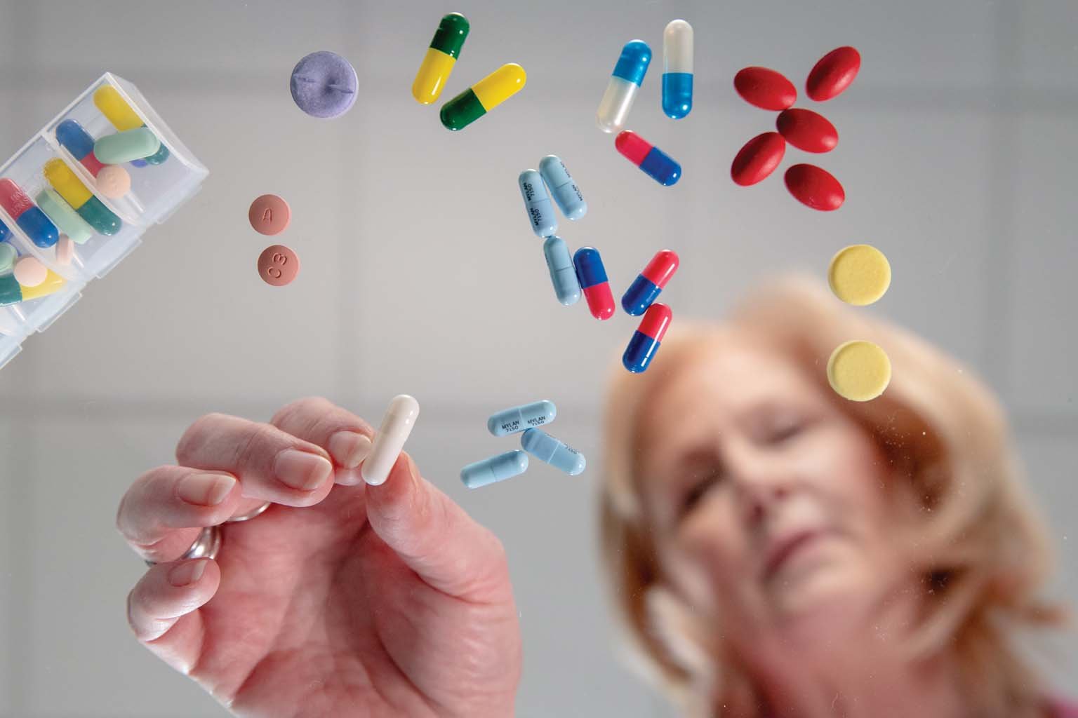 patient sorting through a variety of pills