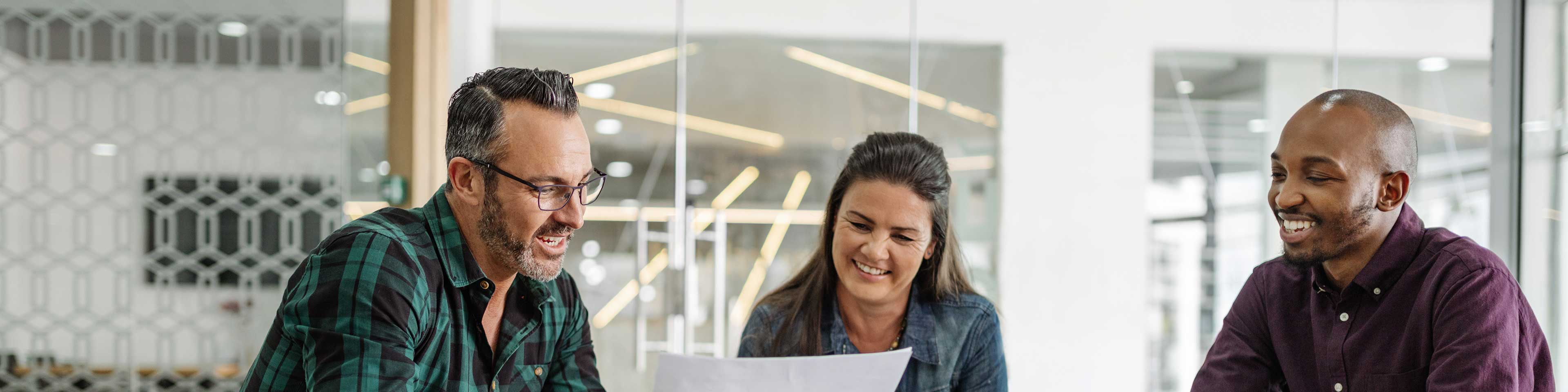 Three businesspeople reviewing a document