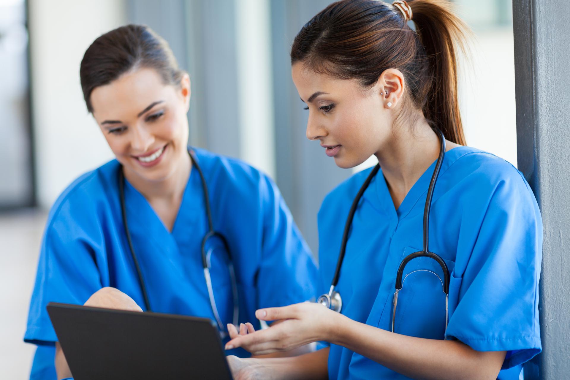 Two nurses using Ovid Synthesis Clinical Evidence Manager on a tablet