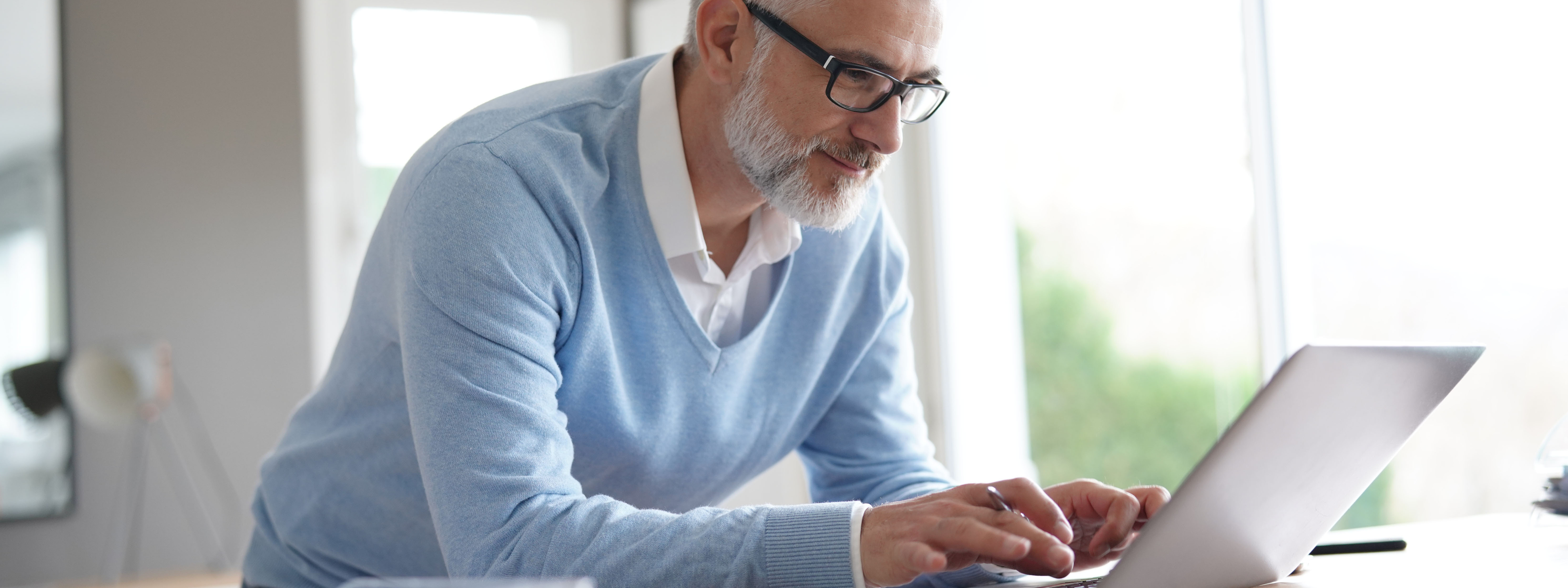 Mature man working on his laptop