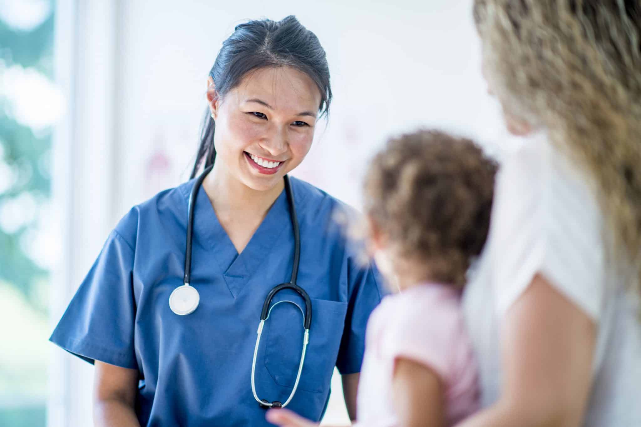 Female doctor with a young girl patient and her mother