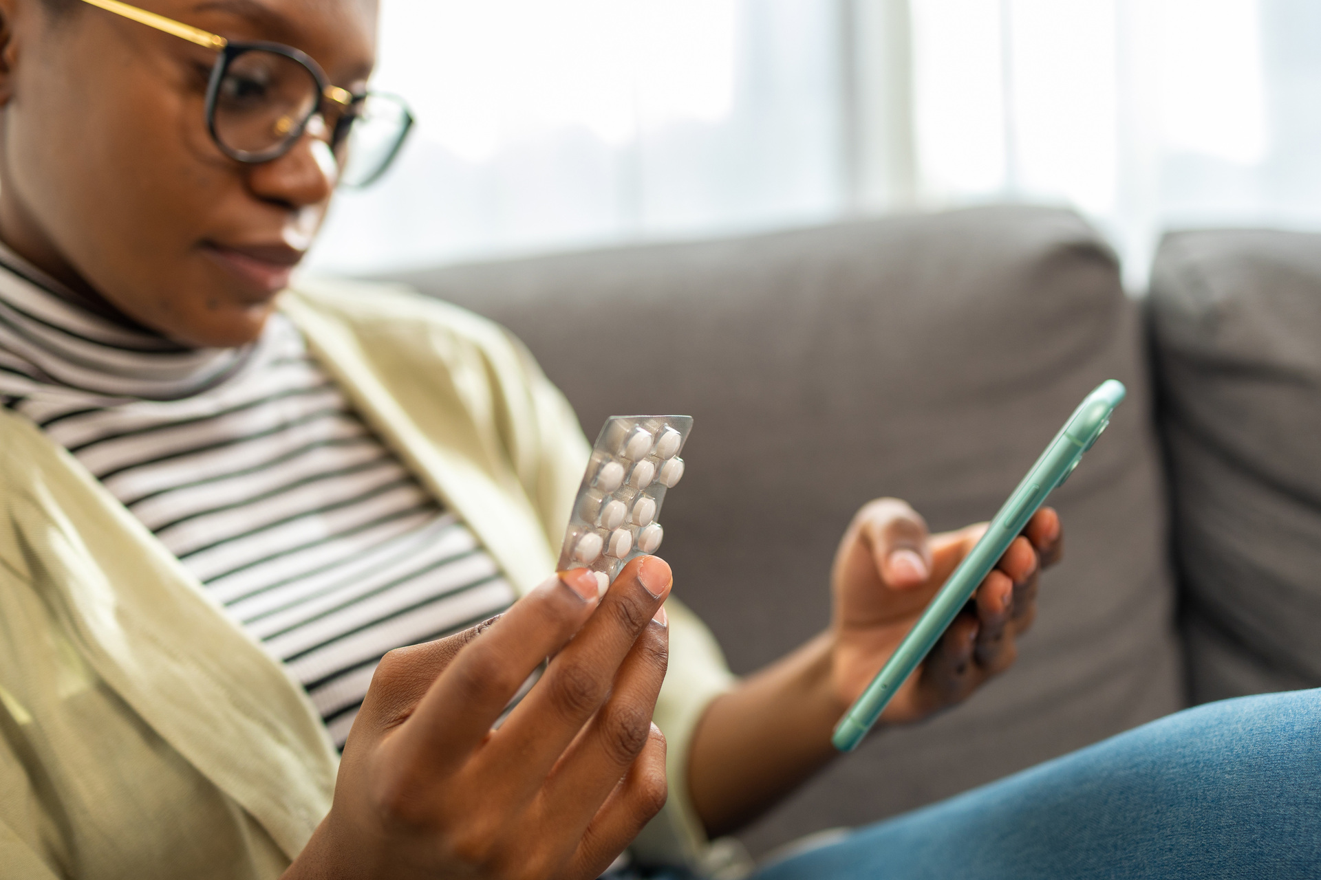 Close up of Smiling African American woman checking online supplement information