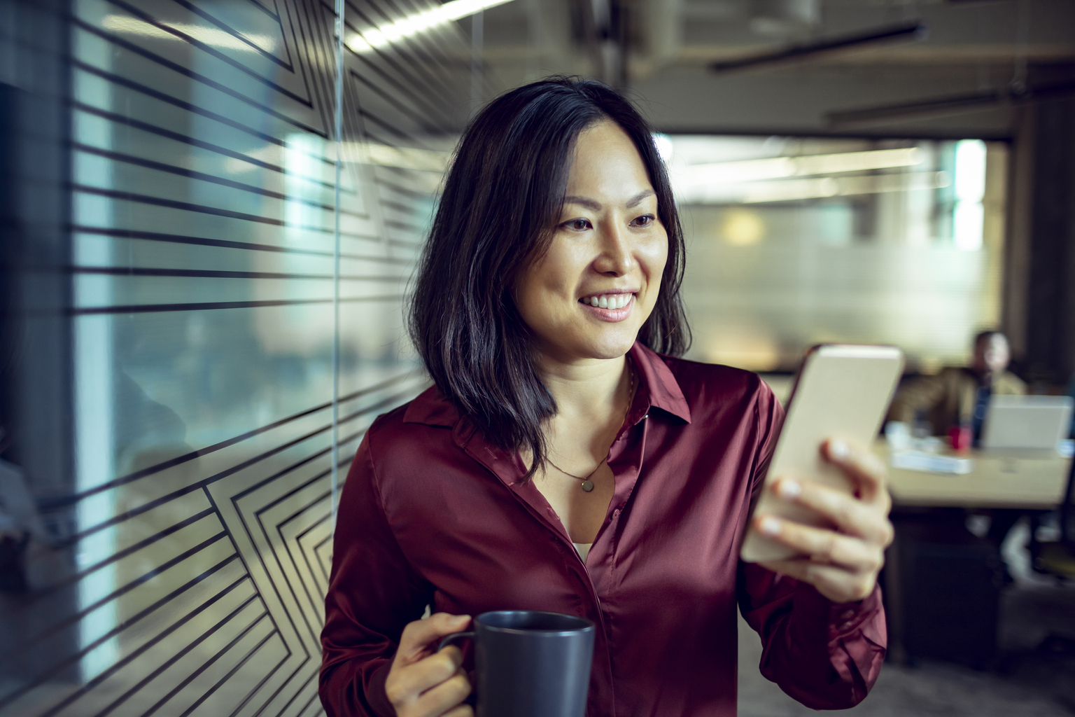 Close up of a businesswoman using her phone in the office