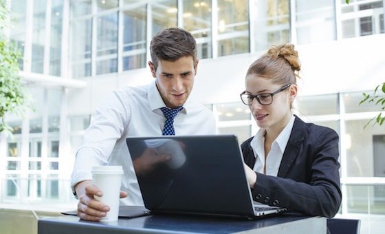 Man and woman looking at laptop