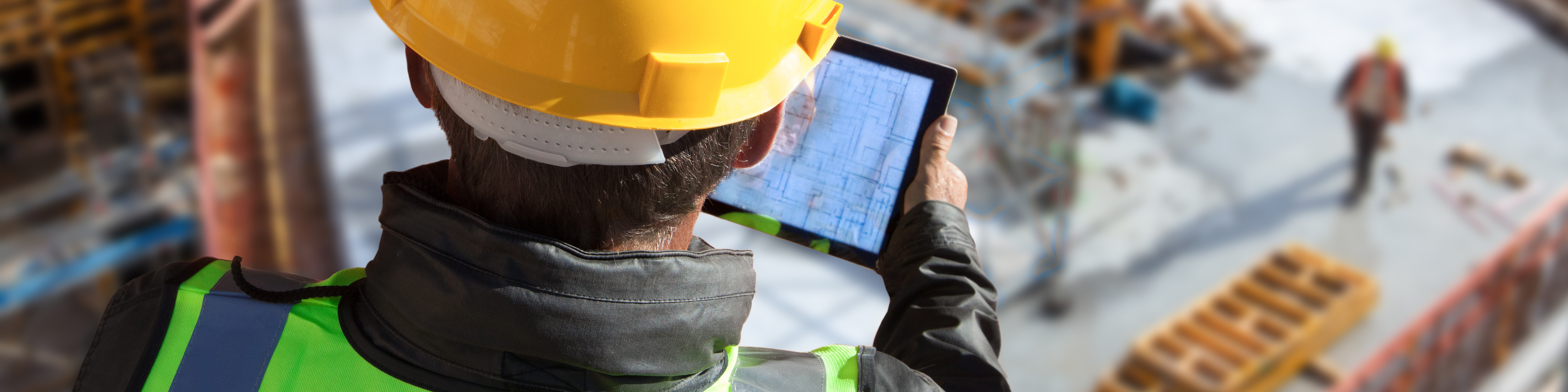 architect engineer construction worker with hard hat working on site with tablet computer