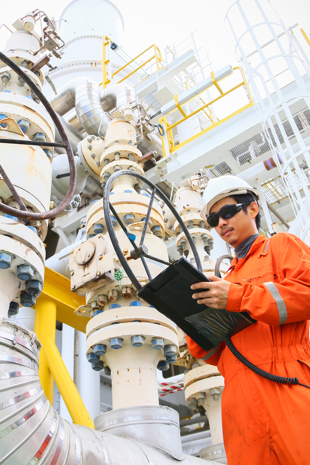 operator recording operation of oil and gas process at oil and rig plant, offshore oil and gas industry, offshore oil and rig in the sea, operator monitor production process, routine daily record.