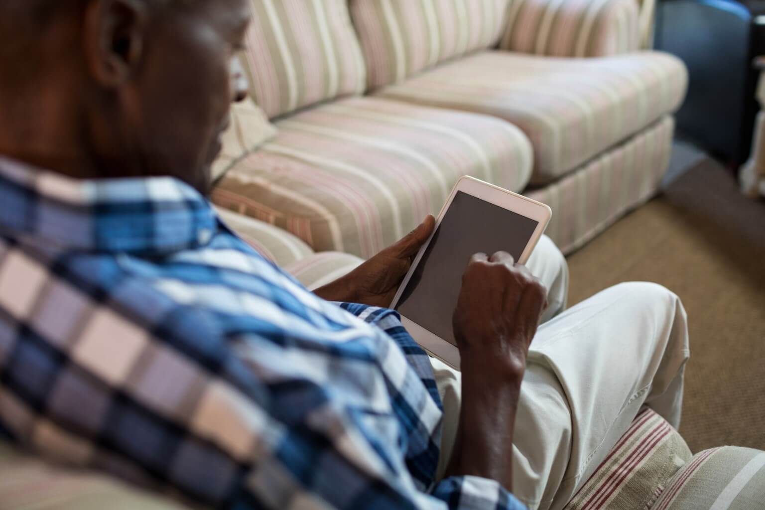 Elderly man consulting a physician via telemedicine