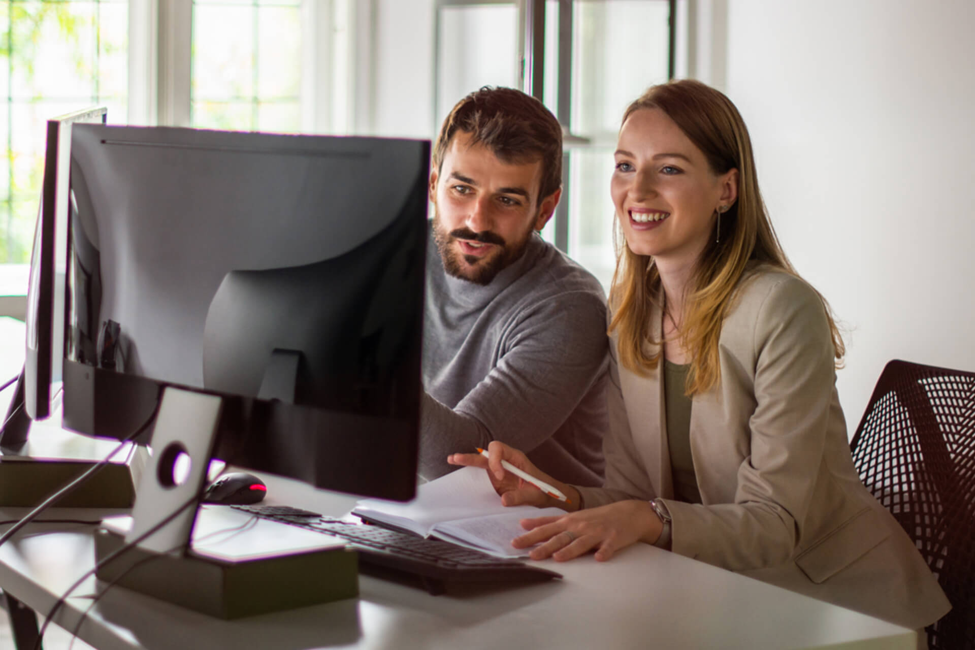 Man and women looking at computer