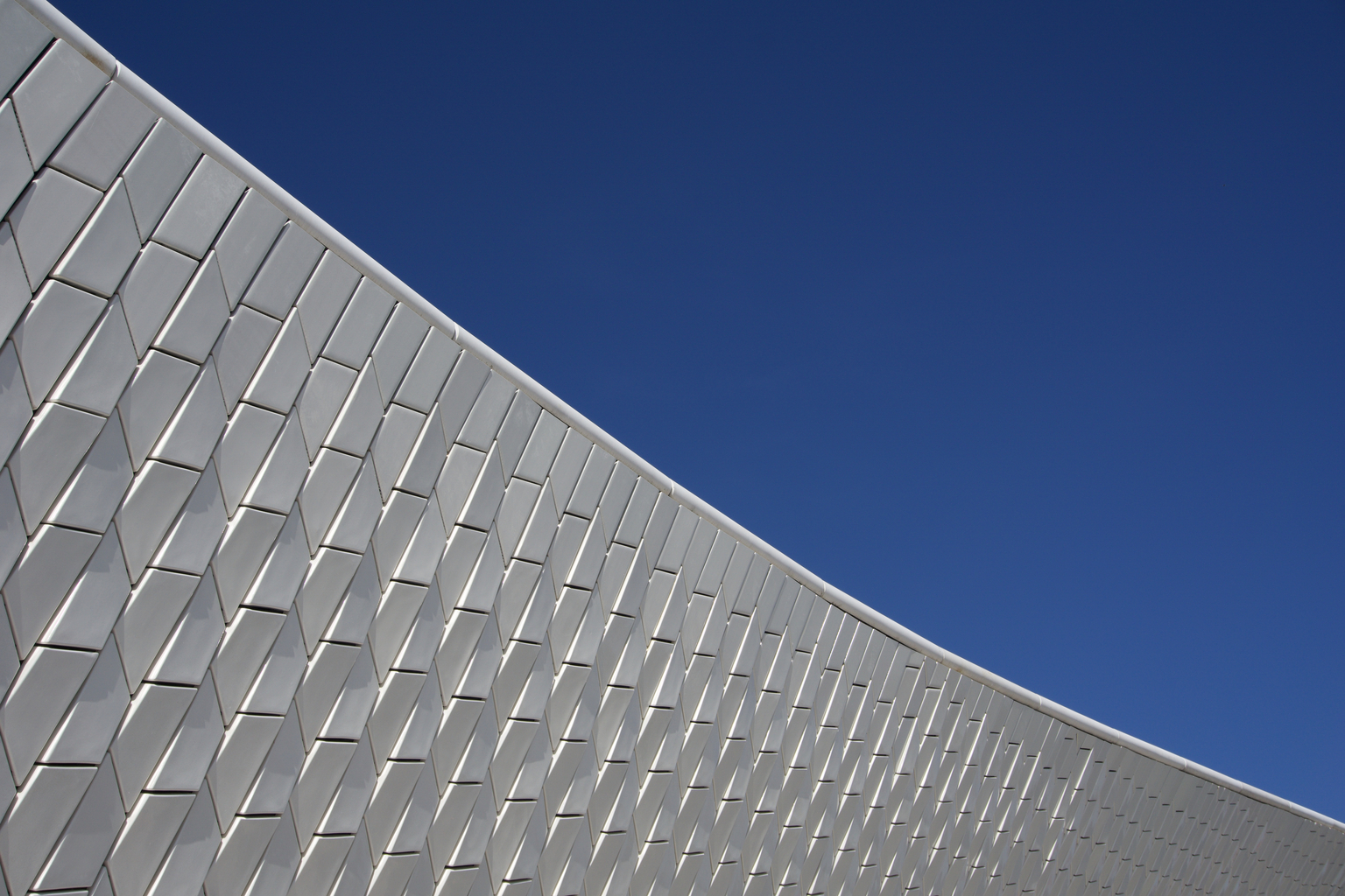 Low Angle View Of Modern Building Against Clear Blue Sky