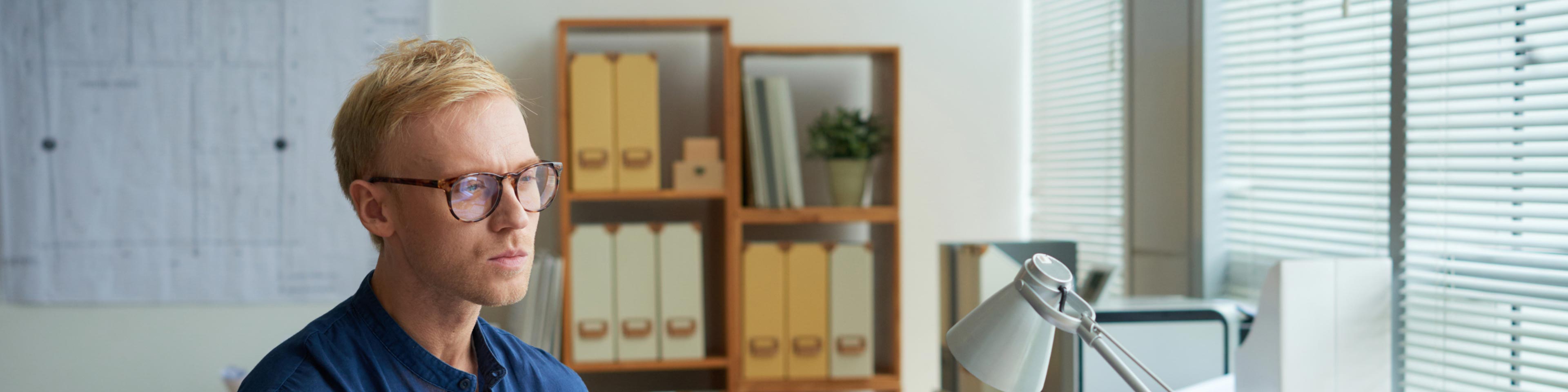 man at desk reviewing equipment leasing