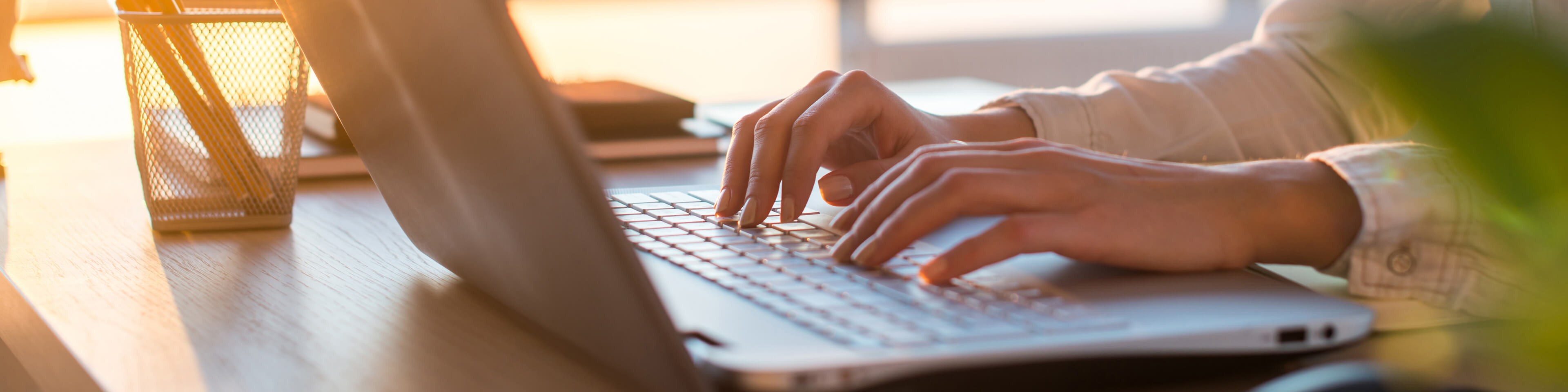 close up of person typing on a laptop