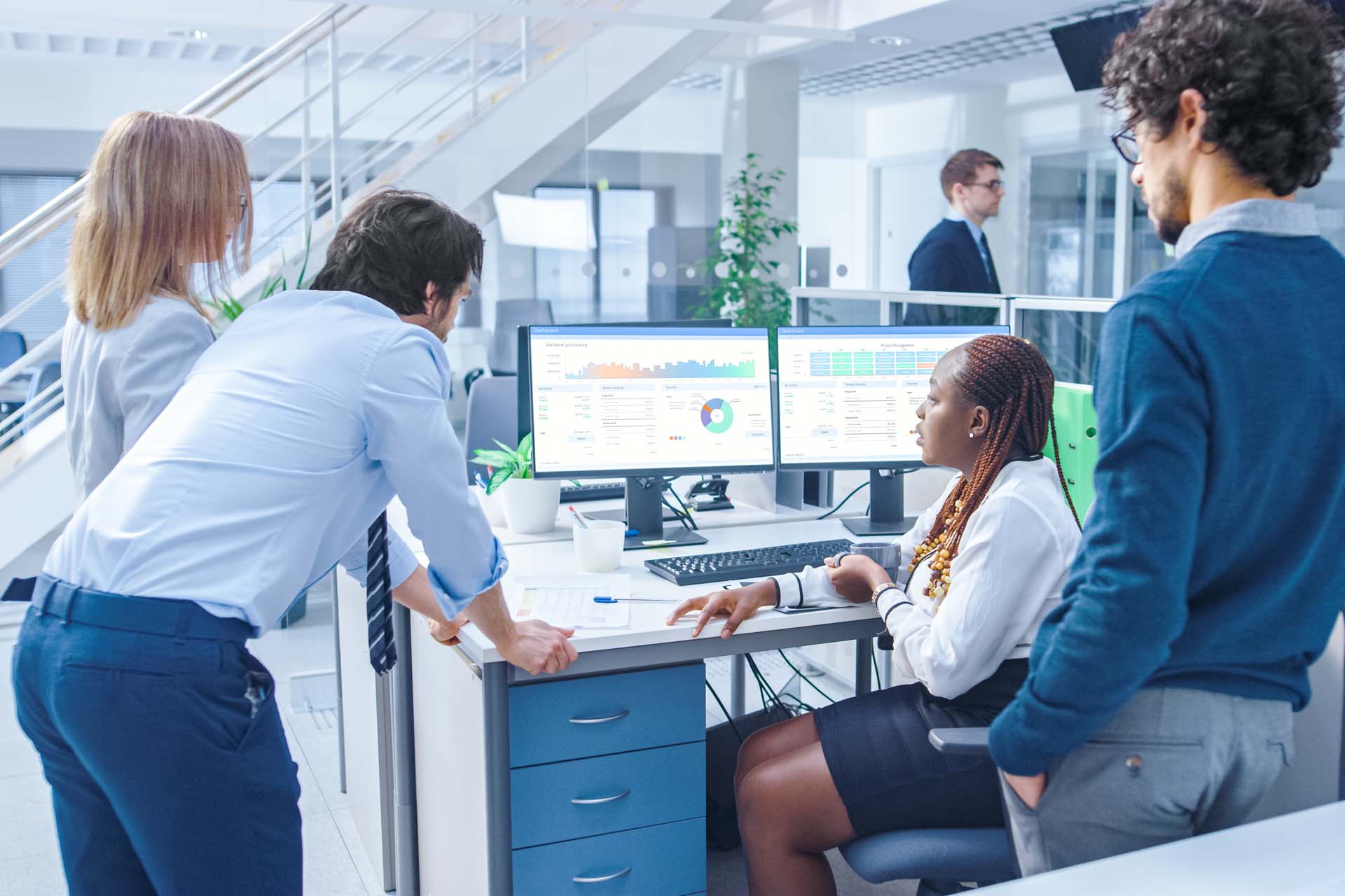 business people looking at computer monitors