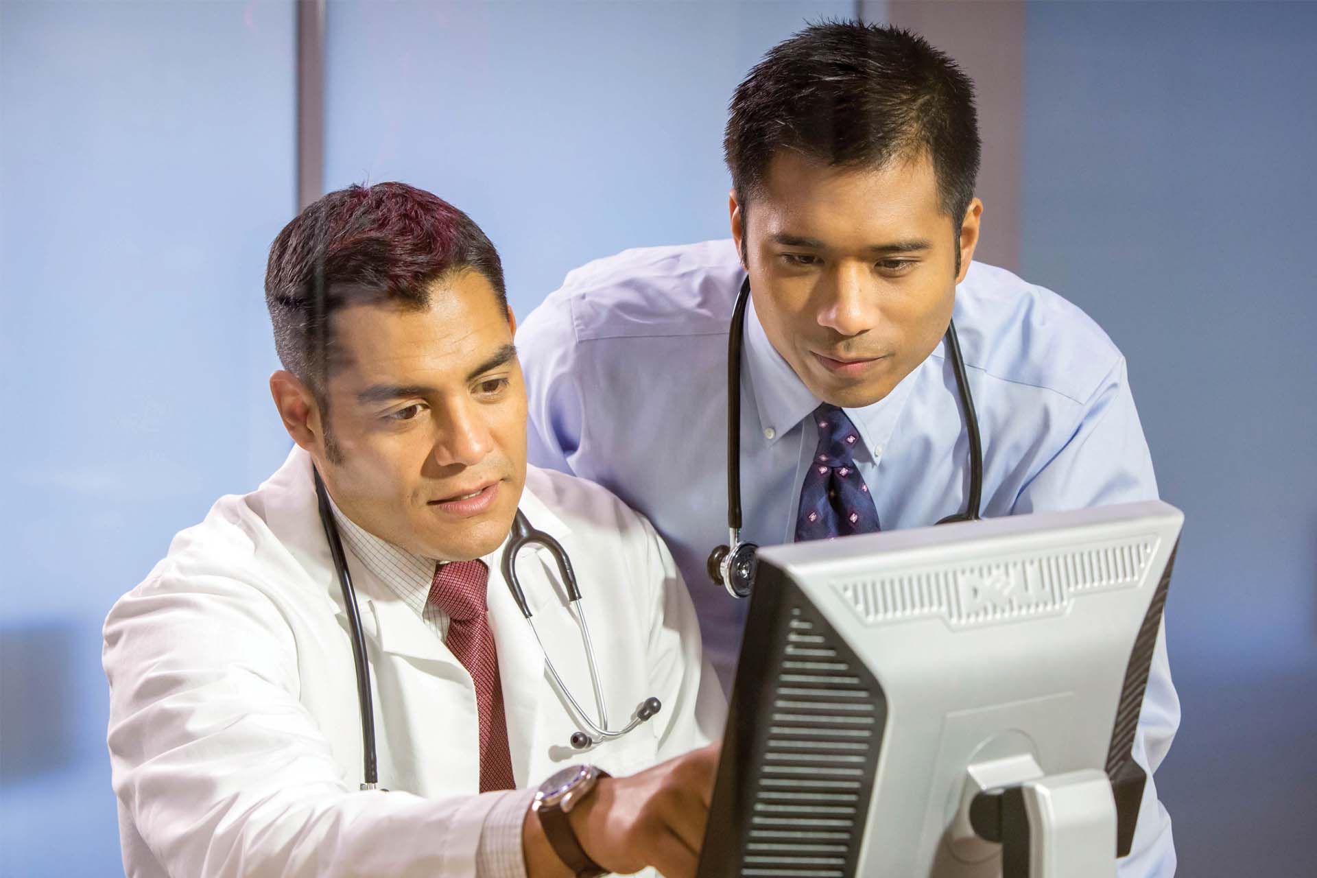 two clinicians at computer screen