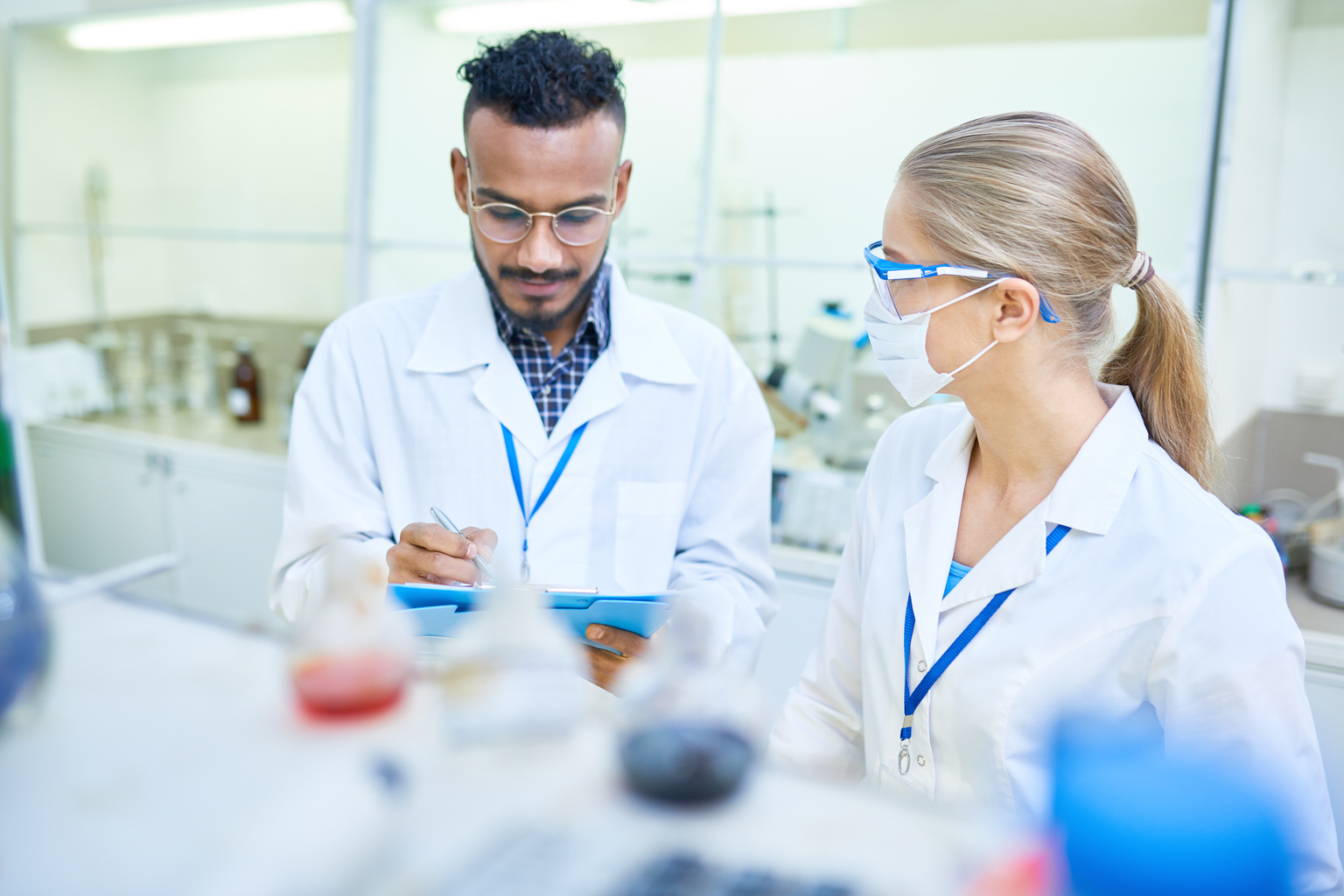 Two medical professional colleagues working together in a labratory