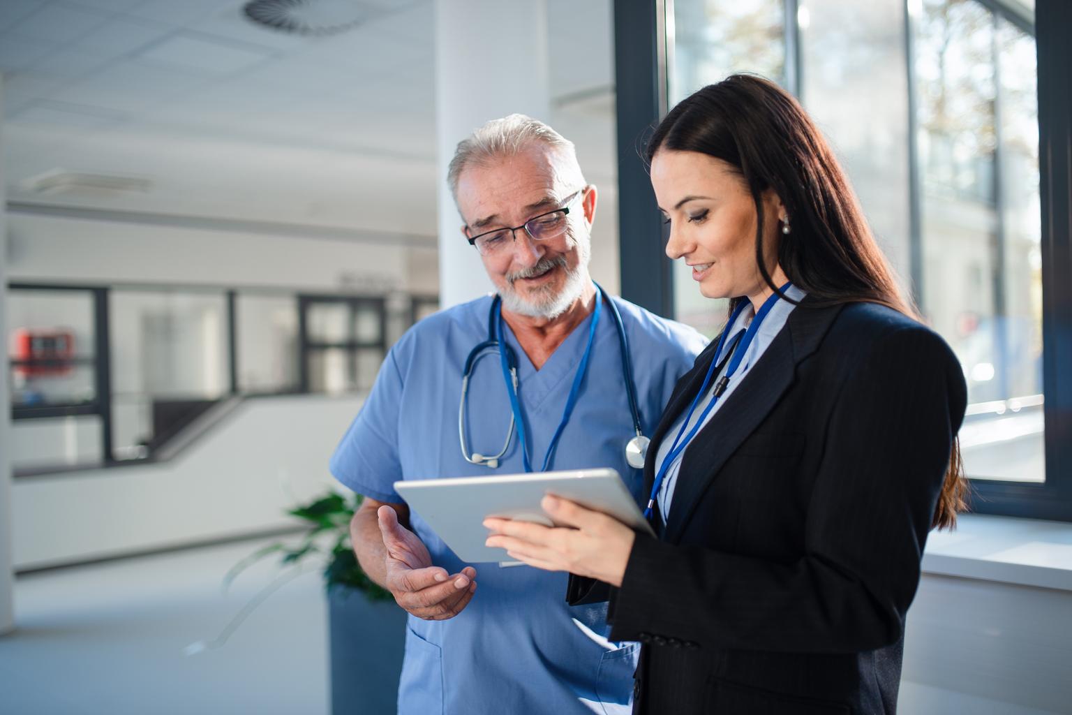 Young pharmaceutic seller explaining something to doctor in hospital