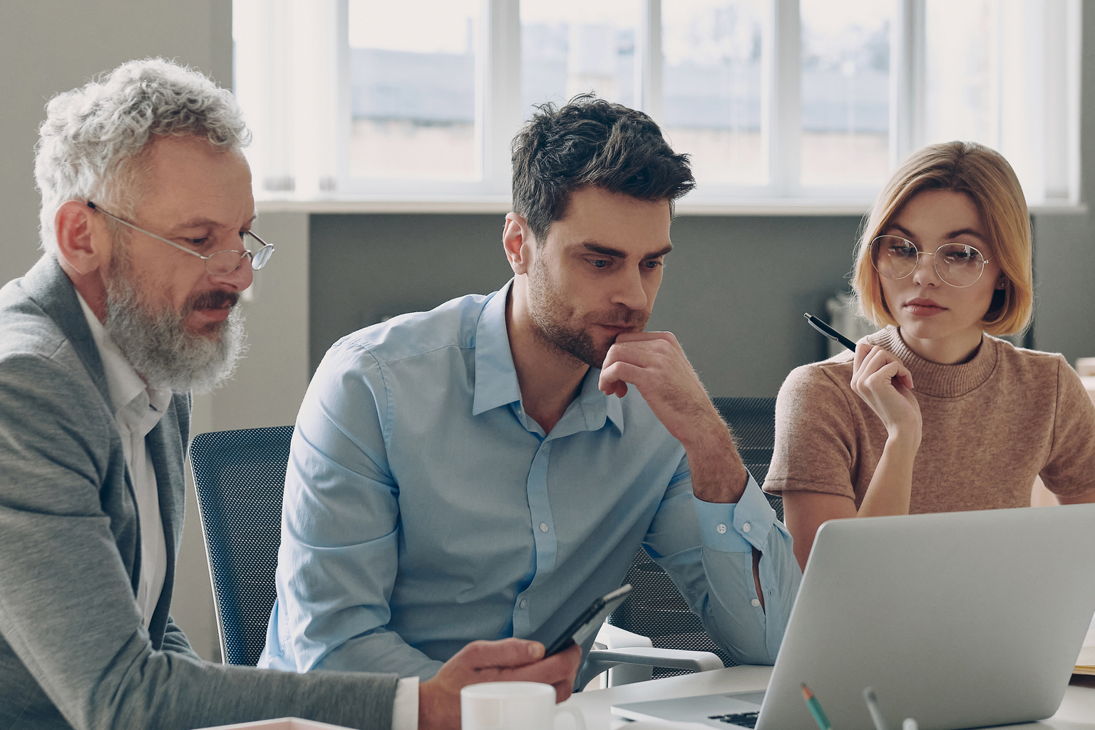 3 persons in front of a laptop