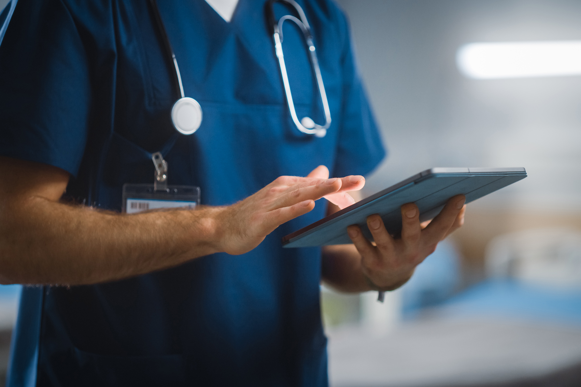 Close up on healthcare provider using tablet