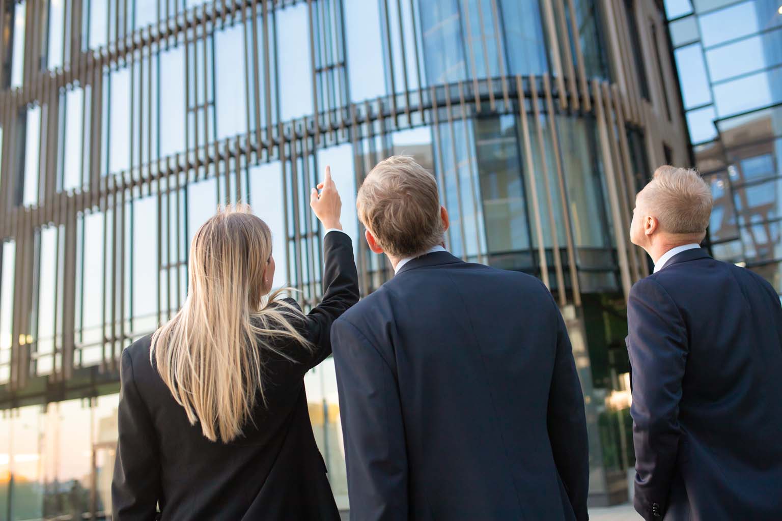 people look up at an office building