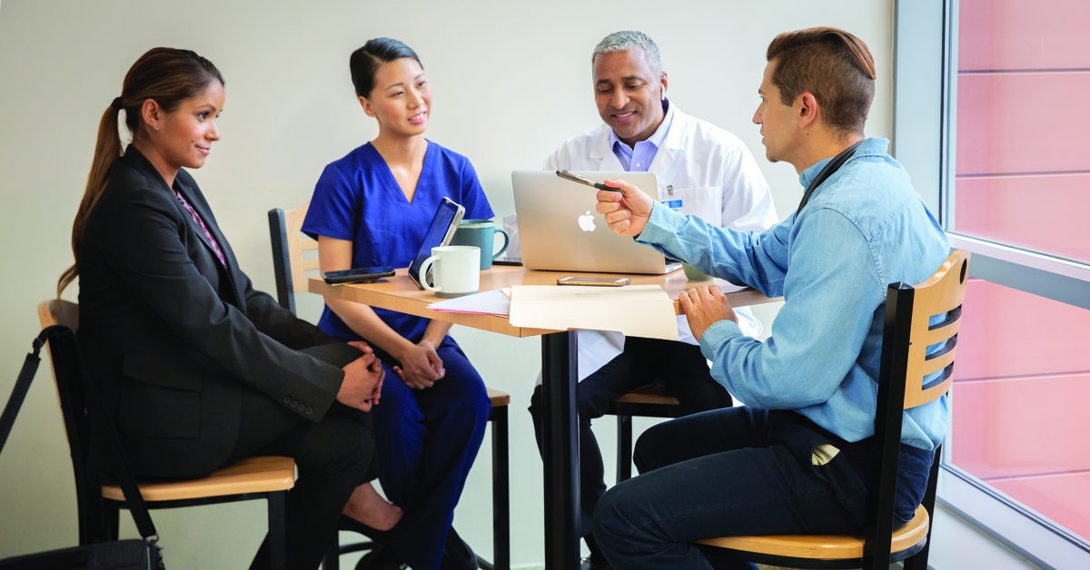 Group of Healthcare workers and hospital staff sitting at table in a meeting