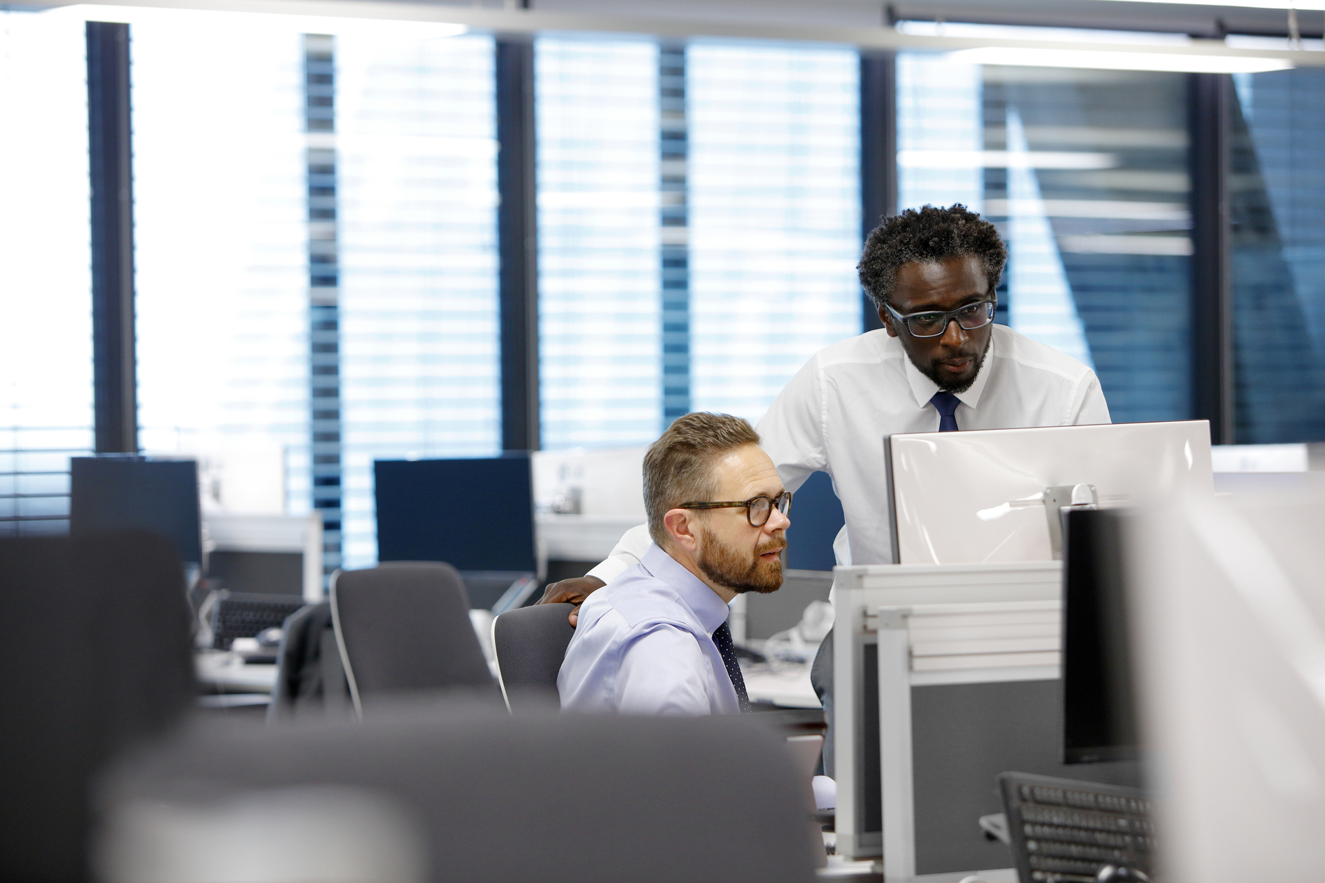 Business colleagues looking at a computer in the office