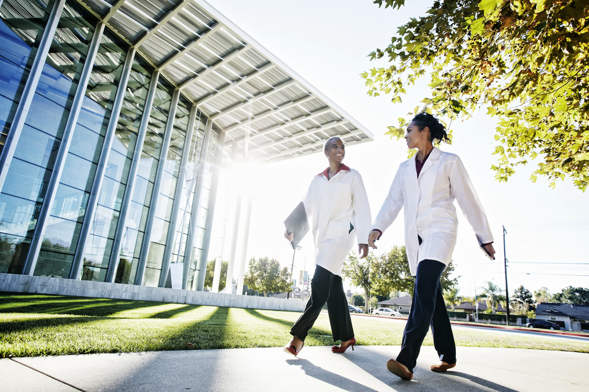 Doctors walking and talking outdoors at hospital